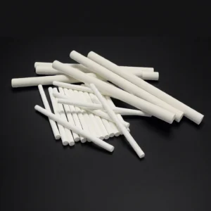 Precision-machined magnesium oxide ceramic rods from China supplier ADCERAX, used for insulation and laboratory equipment.