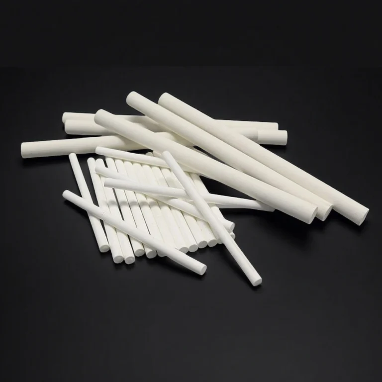 Precision-machined magnesium oxide ceramic rods from China supplier ADCERAX, used for insulation and laboratory equipment.