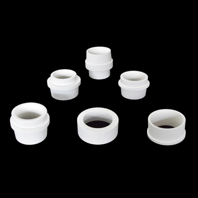 Close-up of aluminum titanate sprue bushing showing machined bore and flange