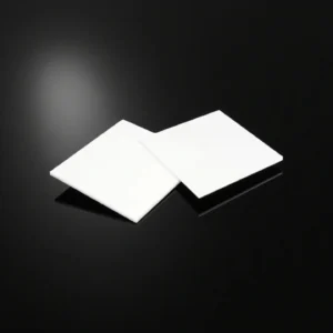 Machinable glass ceramic plate with holes and slots for vacuum fixture assembly