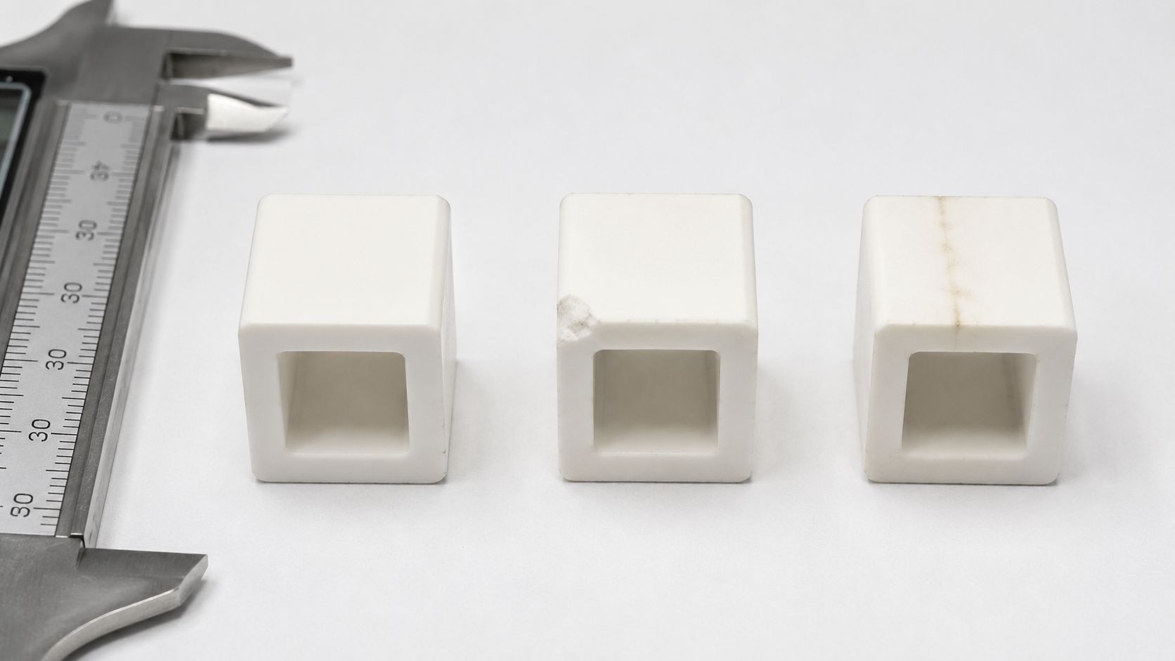 Square alumina tube samples with chips cracks and tracking marks for dielectric inspection