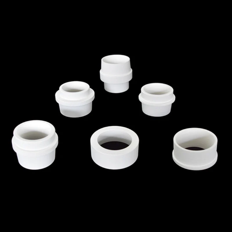 Close-up of aluminum titanate sprue bushing showing machined bore and flange