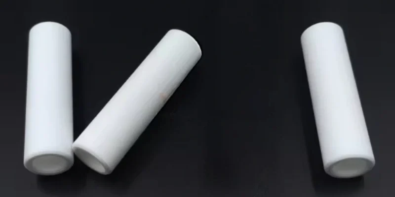 machinable glass ceramic tube machined with side holes and slots for routing and spacing
