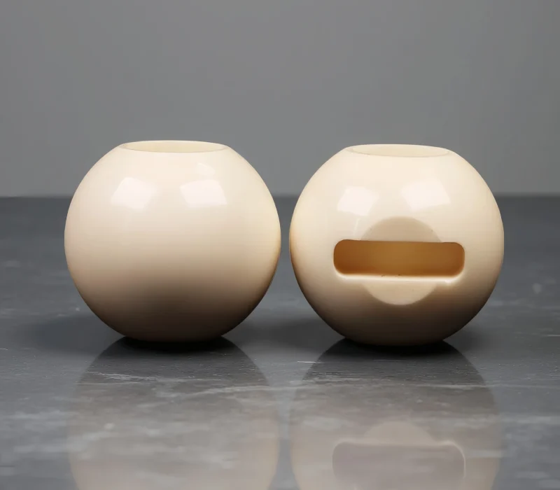 High-purity alumina ceramic ball valve cores with precision machined slot, manufactured by ADCERAX for corrosion-resistant fluid control systems.